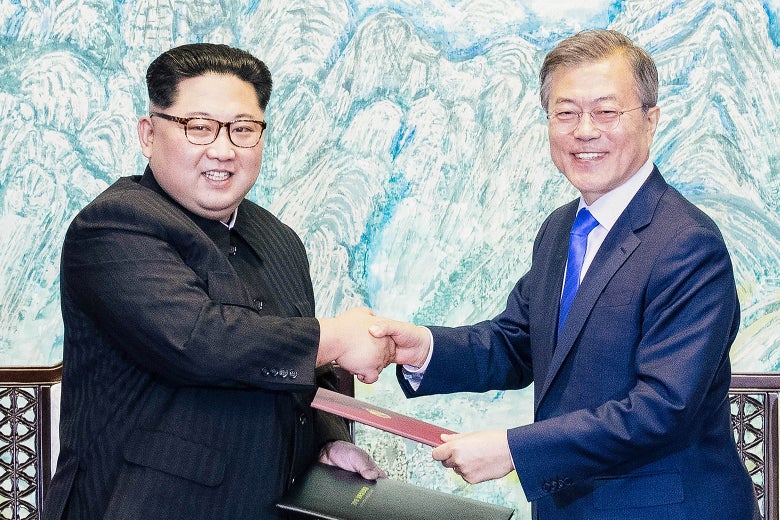 Kim Jong-un and Moon Jae-in shake hands.